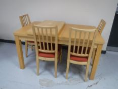 A contemporary pine effect extending kitchen table with leaf together with a set of four rail back