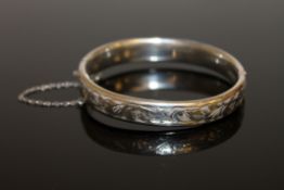 An engraved silver bangle,