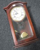 A mahogany cased Highlands wall clock with key and pendulum