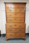 A George III oak chest on chest fitted with nine drawers, width 106 cm.