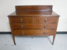A Victorian inlaid mahogany four drawer chest