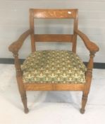 An early 20th century tapestry seated continental oak armchair