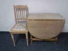 A pine gateleg table together with a pine bedroom chair