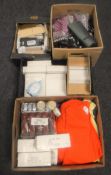 Four boxes containing t-shirts, shoe care products, novelty picture frames, purses,