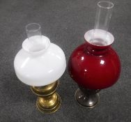 Two vintage brass oil lamps with glass chimneys and shades