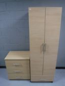 A pine effect double door wardrobe fitted a drawer together with matching three drawer chest