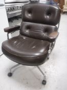 A 20th century chrome framed brown buttoned leather swivel office armchair
