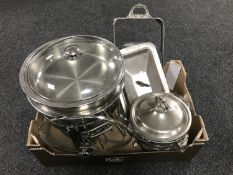 A box containing stainless steel chafing dishes on stands with covers