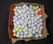 A box containing a large quantity of golf balls