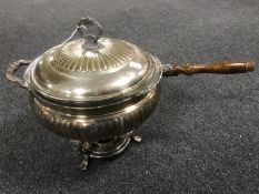 An antique silver plated long handled chafing dish with glass liner,