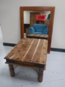 A Mexican pine coffee table with metal mounts together with a pine wall mirror