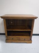 A contemporary mango wood entertainment stand fitted two drawers