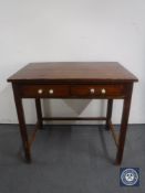 An early 20th century pine table fitted two drawers