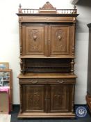 An antique French walnut hunting cabinet with carved panel doors