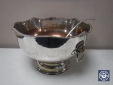 A silver on copper punch bowl with lion mask handles and ladle