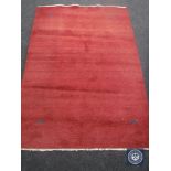 A red fringed woollen rug