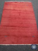 A red fringed woollen rug