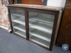 An antique mahogany glazed door bookcase base