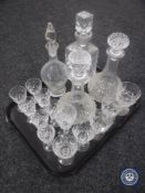 A tray of assorted drinking glasses and four decanters