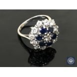 An 18ct white gold diamond and sapphire cluster ring, approximately 0.9ct.