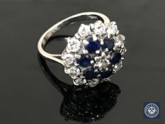 An 18ct white gold diamond and sapphire cluster ring, approximately 0.9ct.