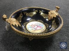 A large Limoges fruit bowl with gilt metal rim and handles with metal base