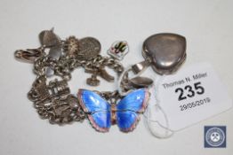 A sterling silver enamel butterfly brooch together with a silver charm bracelet and a silver heart