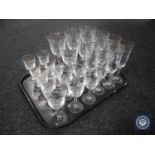 A tray of four sets of six etched glasses - champagne flutes, wine glasses,