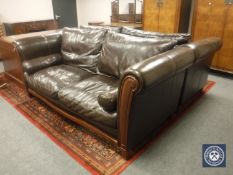A pair of large Barker & Stonehouse brown leather two seater settees with bolster cushions,