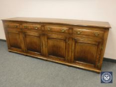 A good quality Georgian style oak dresser fitted with four drawers and cupboard base,