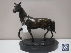 A bronze figure of a horse on marble base