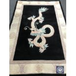 A fringed Chinese with dragon design on black ground