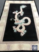 A fringed Chinese with dragon design on black ground