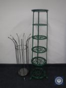 A cast metal five tier plant stand and a metal stick stand