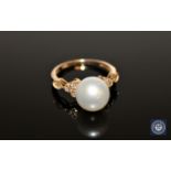 A 14ct yellow gold pearl and diamond ring, the white,