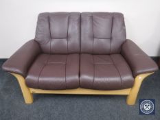 A wood framed brown leather Ekornes two seater settee