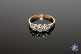 An 18ct gold and platinum set three stone diamond ring, approximately 0.25ct, size K 1/2.
