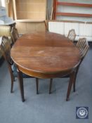 An antique oval dining table with leaf and four chairs