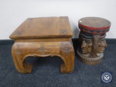 An Eastern mahogany square lamp table with floral carving and a hardwood stool depicting native