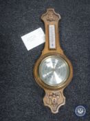 A carved oak cased banjo barometer by Comitti of London