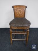 A breakfast bar stool with tooled leather panelled back