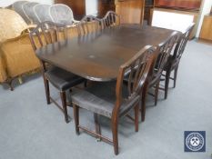 A mahogany twin pedestal Regency style dining table and six shield back chairs