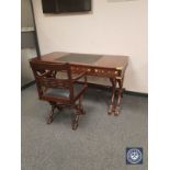 A good quality mahogany campaign style writing table, on X-frame support, with brass inlay,