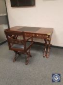 A good quality mahogany campaign style writing table, on X-frame support, with brass inlay,