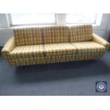 A mid 20th century three seater settee in yellow fabric on teak legs CONDITION REPORT: