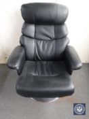 A black leather swivel adjustable armchair on chrome base