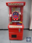A late 20th century toy vending machine and keys