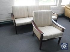 A 1970's teak framed three seater settee and armchair in striped fabric