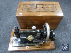 An inlaid mahogany cased German hand sewing machine