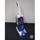 A Vax Dual V Advance Reach carpet washer and bag of accessories and cleaning fluid